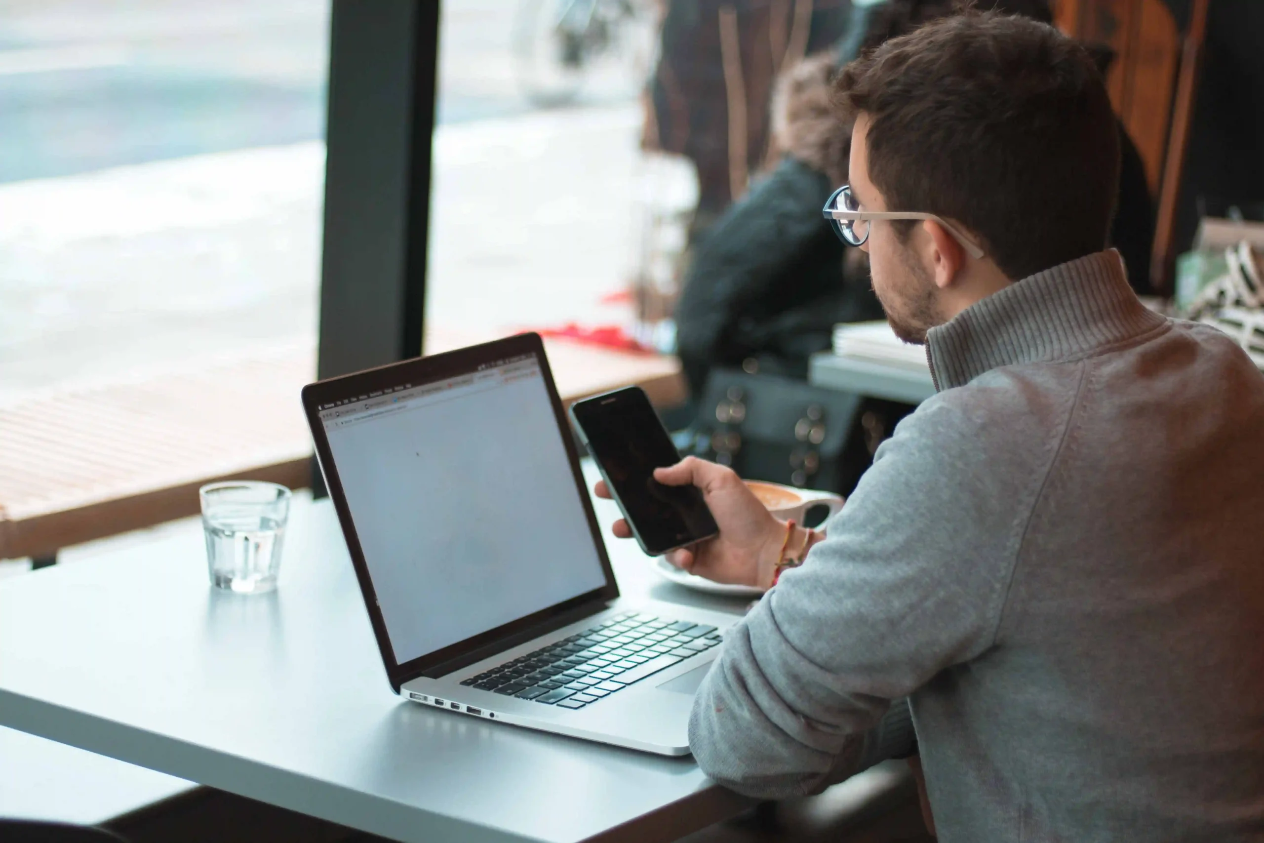 Person on phone and computer