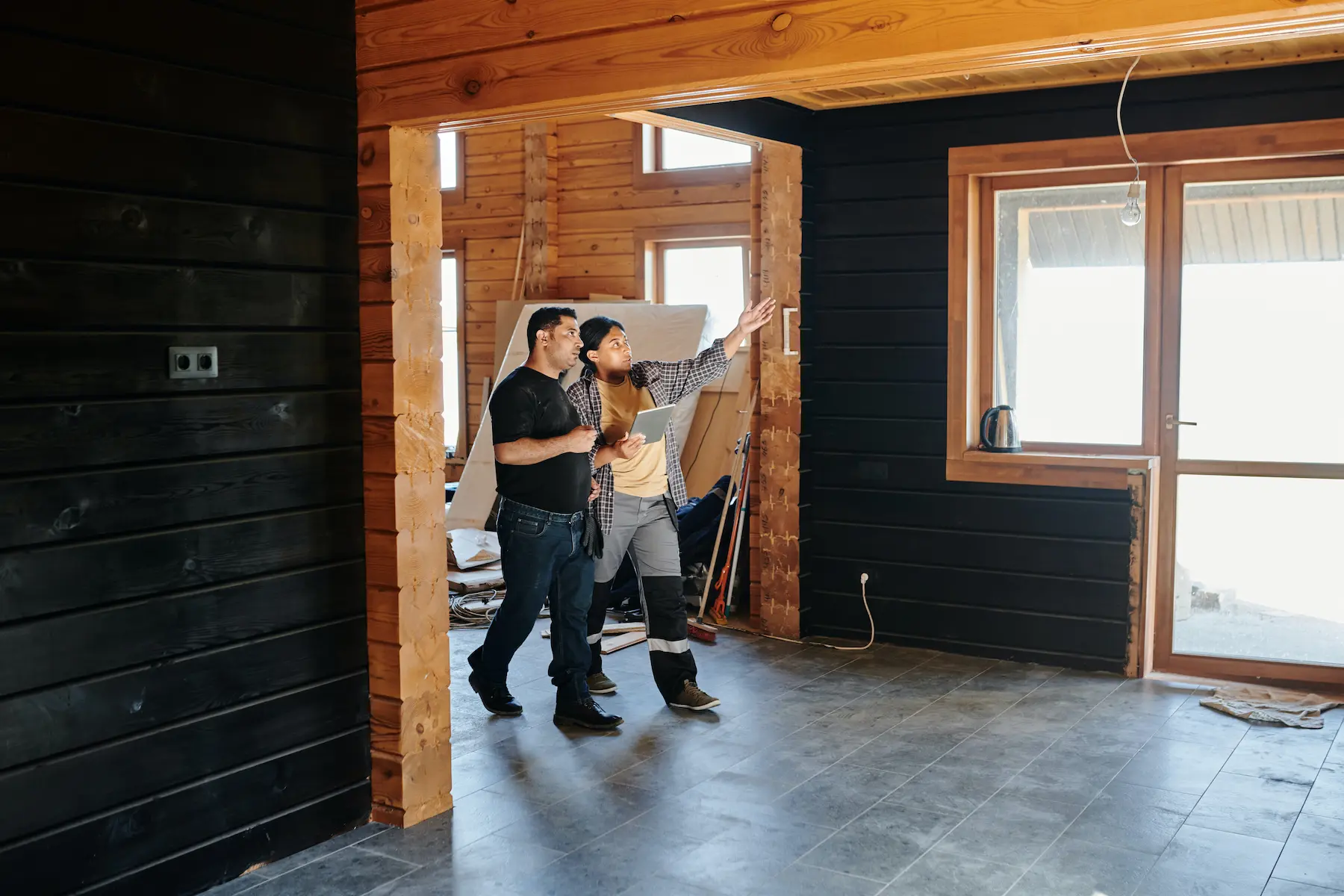 People walking through building doing renovation