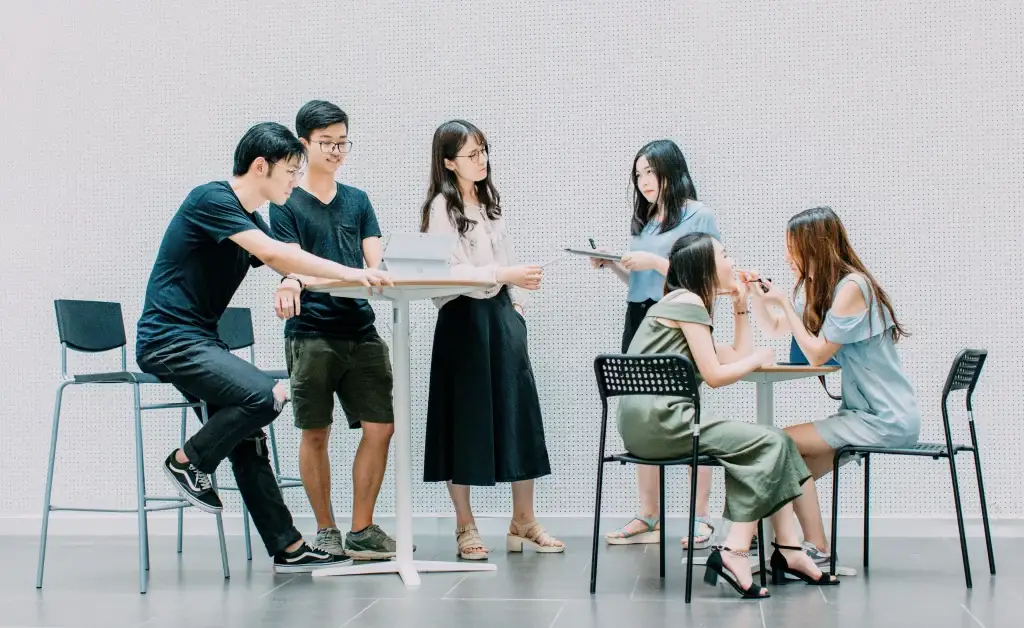 Group of people discussing with one another in a coworking space