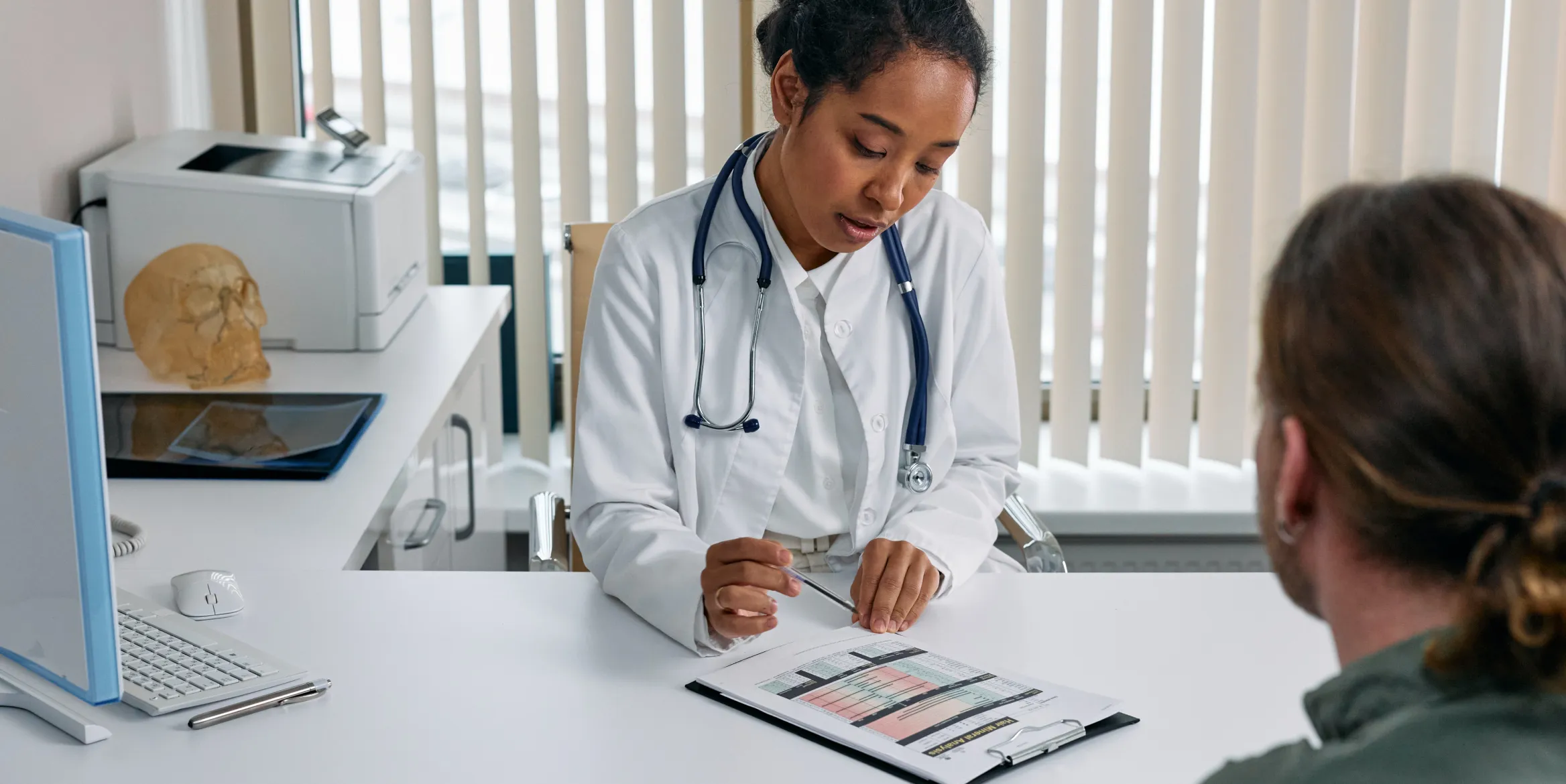 A coworking medical practitioner in a medical coworking or flex space talking to a patient